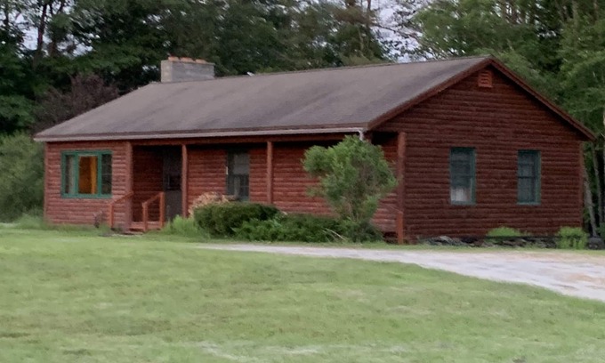 Newport Cabin | Cabin is nestled near the Sugar River in a country setting next to a open field.