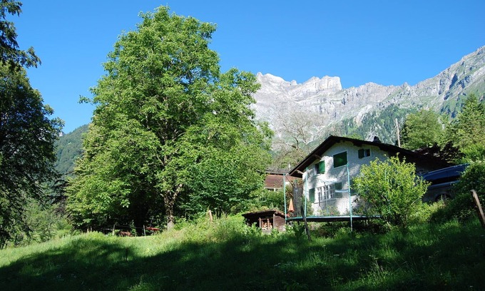 Schwanden Ski Chalet | Chalet on the edge of the forest with a view of the waterfall right next door