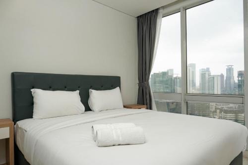 Karet Apartment | Comfortable Deluxe 2BR at The Empyreal Condominium Epicentrum Apartment By Travelio