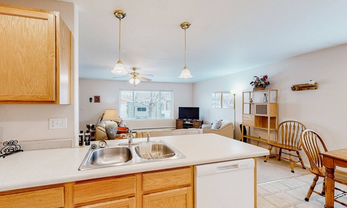 Pear Park House | Comfortable retreat with open layout, mountain views, enclosed yard, grill, & AC