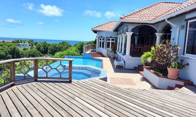 Arawak Hill Villa | Enjoy the tropical breezes & coral reef views while sitting by the pool!