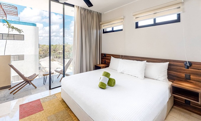 Zama Apartment | Fourth-floor studio with rooftop pool, partial A/C, city views, & balcony