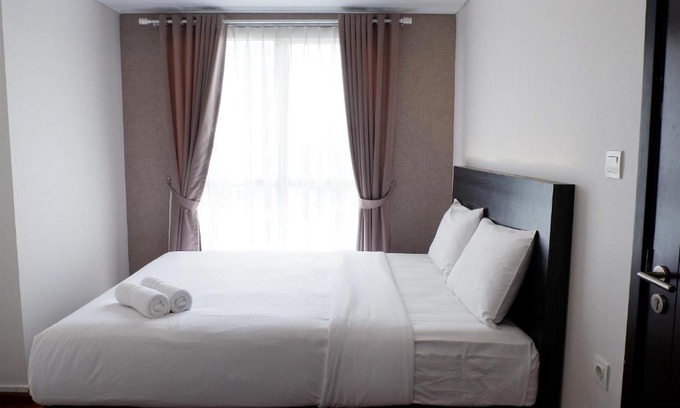 Pagedangan Apartment | Modern 1BR Casa De Parco Apartment By Travelio