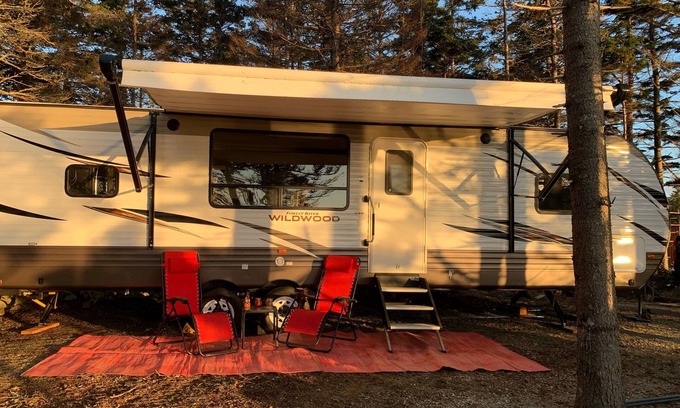 Clare House | Modern RV camper with all the perks nNestled in tree at lake edge