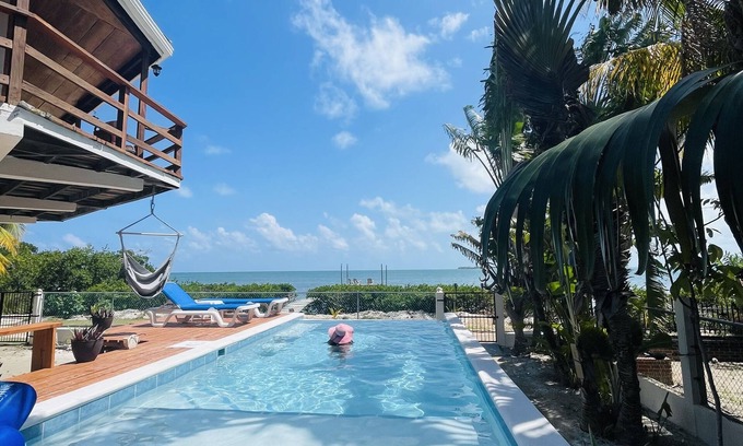 Caye Caulker Apartment | OCEANSIDE 1ST FLOOR APT, OFF-GRID WITH INFINITY EDGE POOL, DOCK, A/C & SMART TV