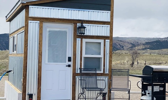 Meeker House | Our tiniest Tiny Home packs a punch! It contains a Queen bed in a loft accessed by a ladder. Sleeps: 2