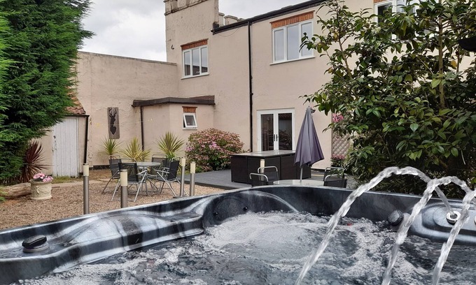 Kneesall Cottage | Relax and unwind at our hot tub retreat, close to activities, trails, water park