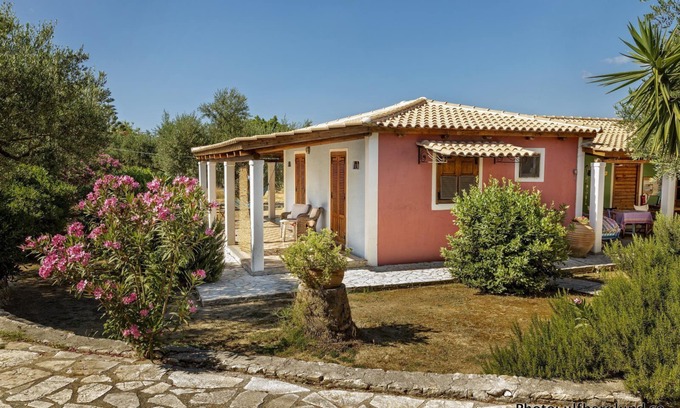 Vasilikos Cottage | Self catered cottage with large veranda and garden with hammock near the beach.