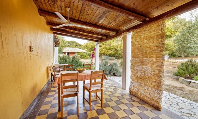 Vasilikos Cottage | Self catered cottage with large veranda and garden with hammock near the beach.