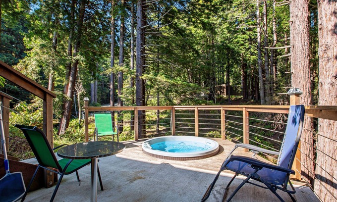 Gualala House | Serene guest suite with shared hot tub, forest views, & splashes of color