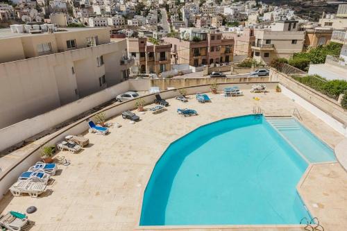 Swieqi Apartment | Spinola Court 2bed W Pool And Parking By Homely