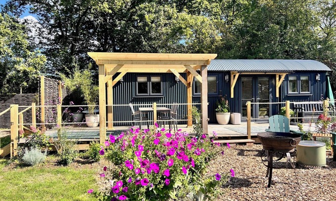 Pulborough Cabin | Sunset - nestled in a wildflower meadow on a farm with Highland Cows