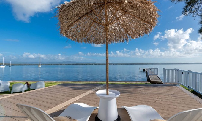 Bonnells Bay Apartment | The Boathouse- Unwind at this tranquil, absolute waterfront, luxury Boathouse nestled on the edge of