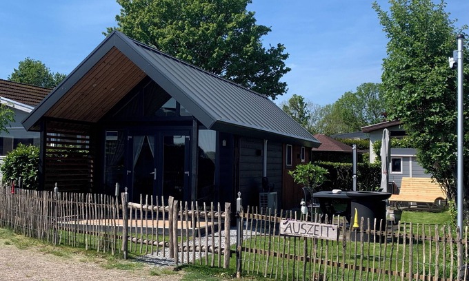 Lathum House | Tiny house time out at the lake and beach. Fenced garden, outdoor shower and fireplace.
