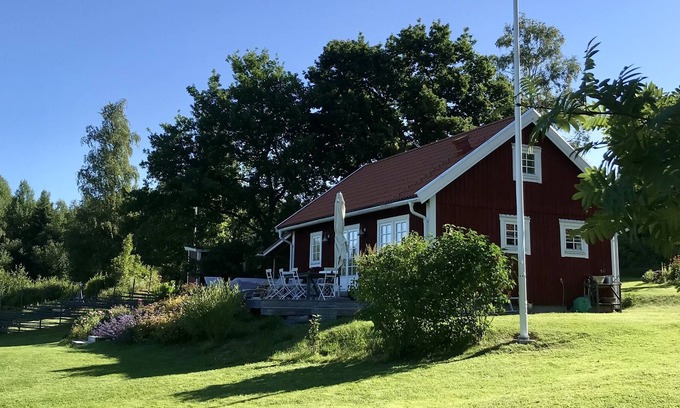 Harnosand Cottage | View of lake and mountains in west orientation, with sauna and jetty