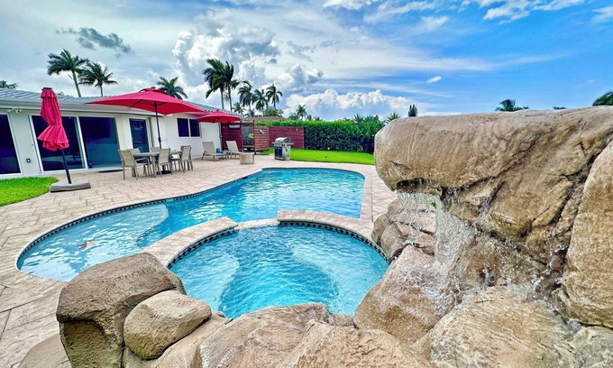 Garden Isles House | Waterfront home with private backyard. Heated pool with waterfall Jacuzzi