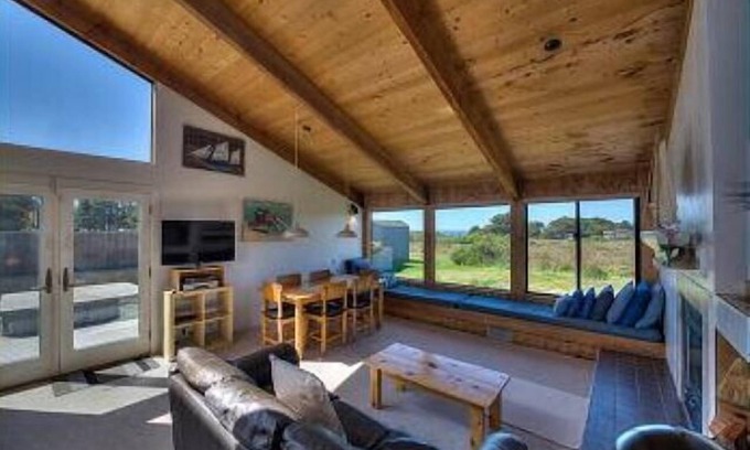 Sea Ranch House | Wide open meadow view with ocean peeks through the trees.