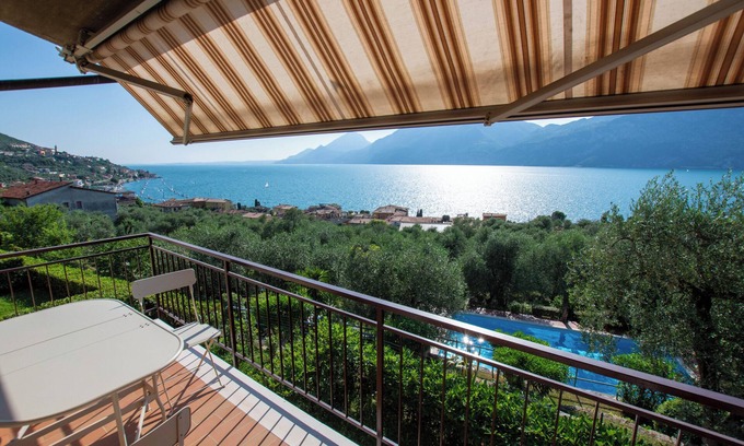 Assenza Apartment | Wonderful balcony on the lake with beautiful pool and garden among palm and olive trees