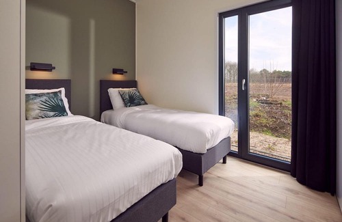 Lattrop House | This holiday home for six persons has a spacious living room with an open kitchen, three bedrooms and a spacious patio.