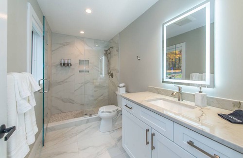 Sparta Township House | Aspen-style lakefront retreat house with hot tub, game room