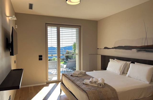 New stylish apartment with panoramic terrace and patio overlooking Lake Como.